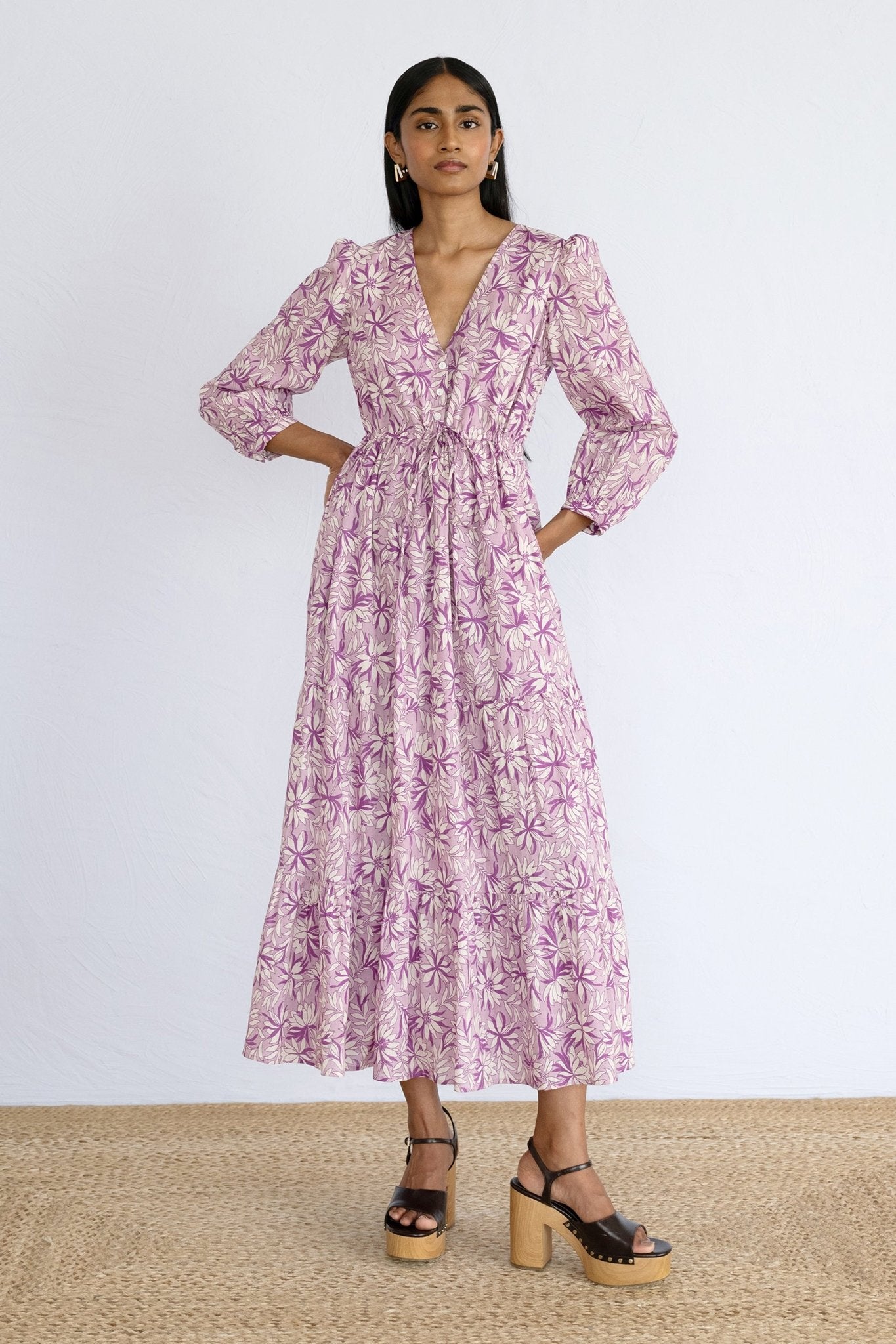 Front view of model standing wearing a full length Castor Dress in Jacaranda Lilac print.