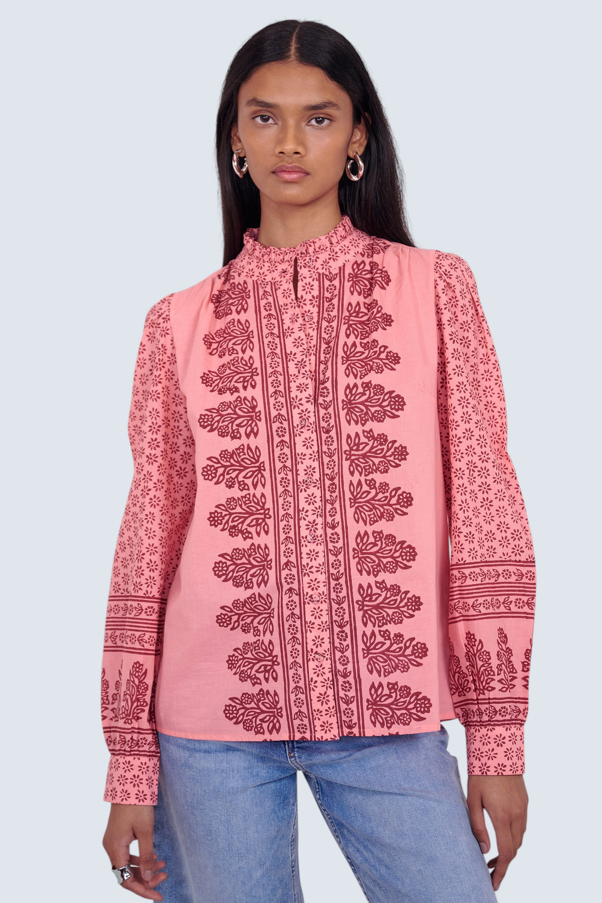 Banjanan Christina shirt in azalea pink with hand-blocked geometric floral print, frilled collar, and puffed sleeves.