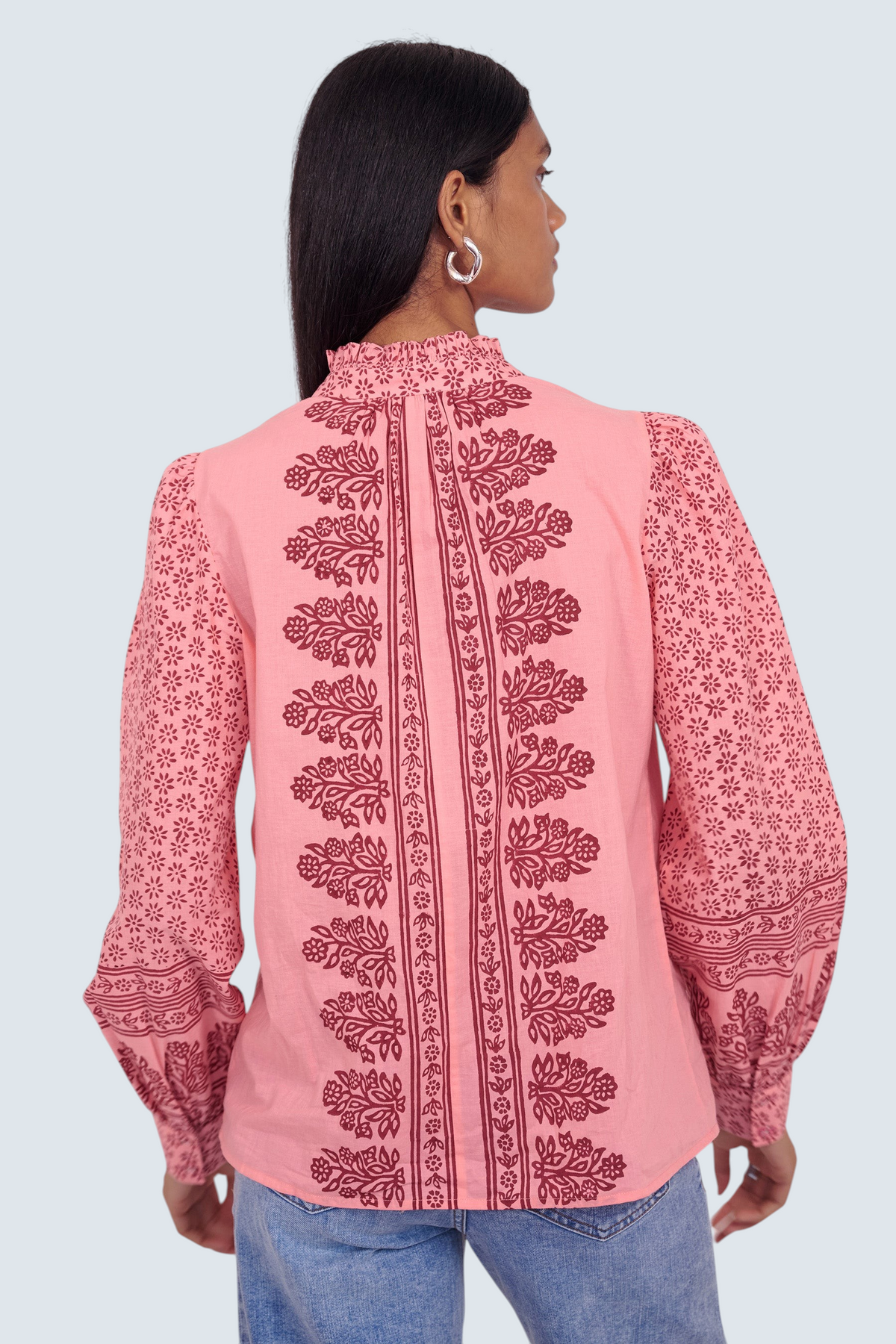 Banjanan Christina shirt in azalea pink with hand-blocked geometric floral print, frilled collar, and puffed sleeves.