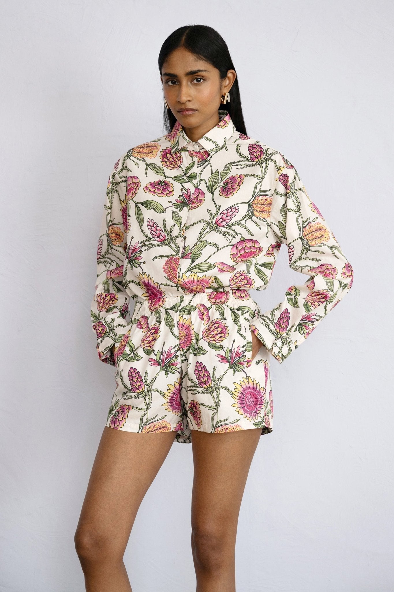 Front view of model standing Evelyn Shorts Protea Cypress paired with tucked in Charlotte shirt in same print.