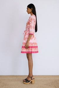 Side view of model standing wearing short length Gizela Dress Botany Bay Pink Mist.