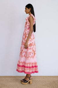 Side view of model standing wearing a full length Hannah Dress Botany Bay Pink Mist.