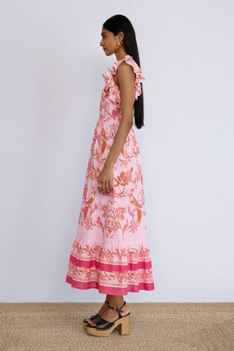 Side view of model standing wearing a full length Hannah Dress Botany Bay Pink Mist.