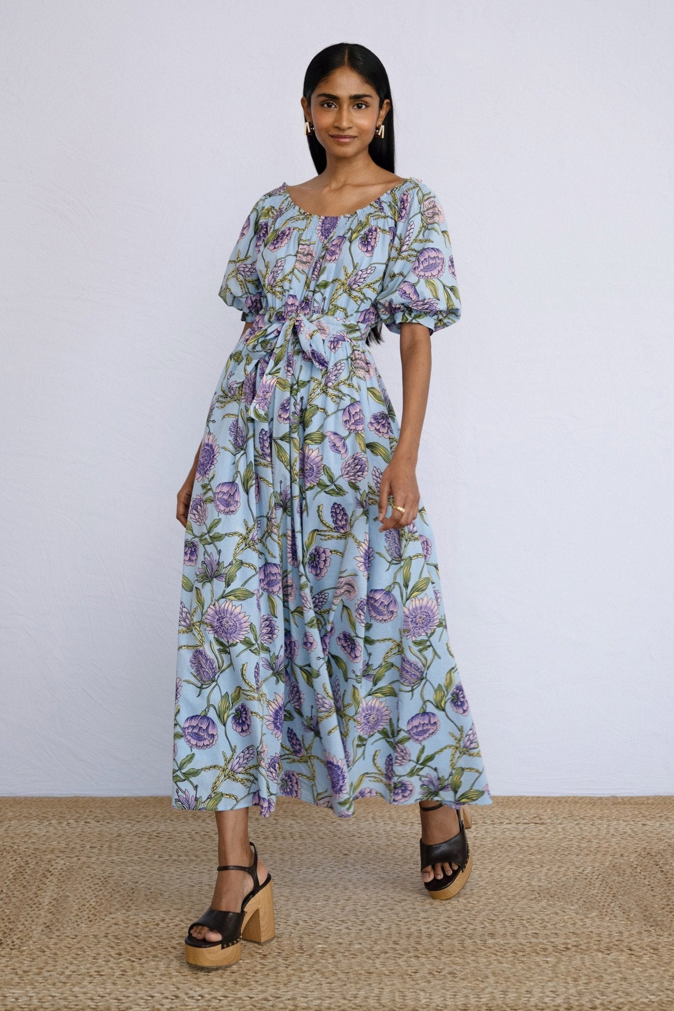 Front side view of model wearing Heidi Dress in Protea Orchid print.