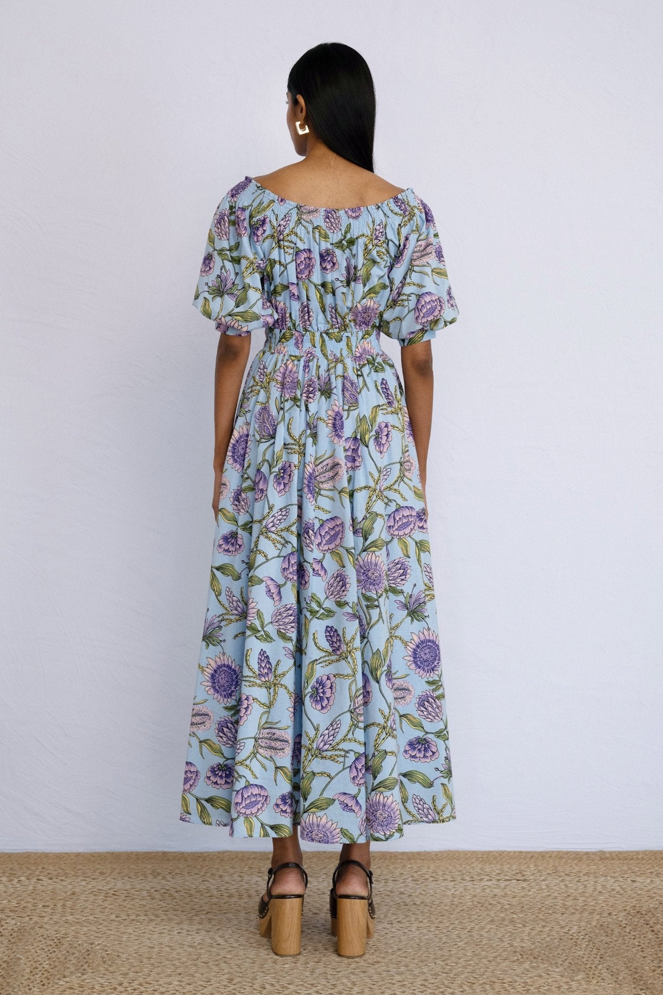 Back view of model standing straight wearing Heidi Dress in Protea Orchid print.