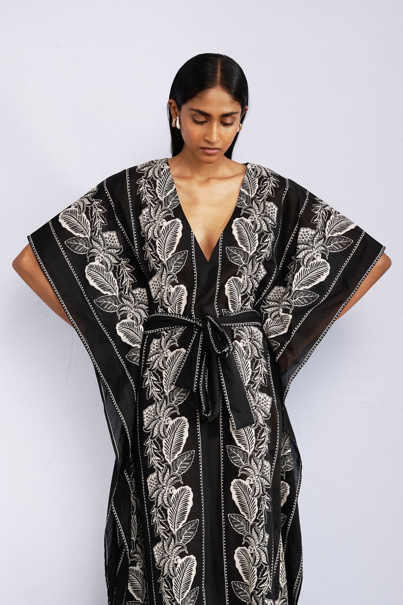 Front view close up of model wearing Jayden Kaftan Lombok Border Black.