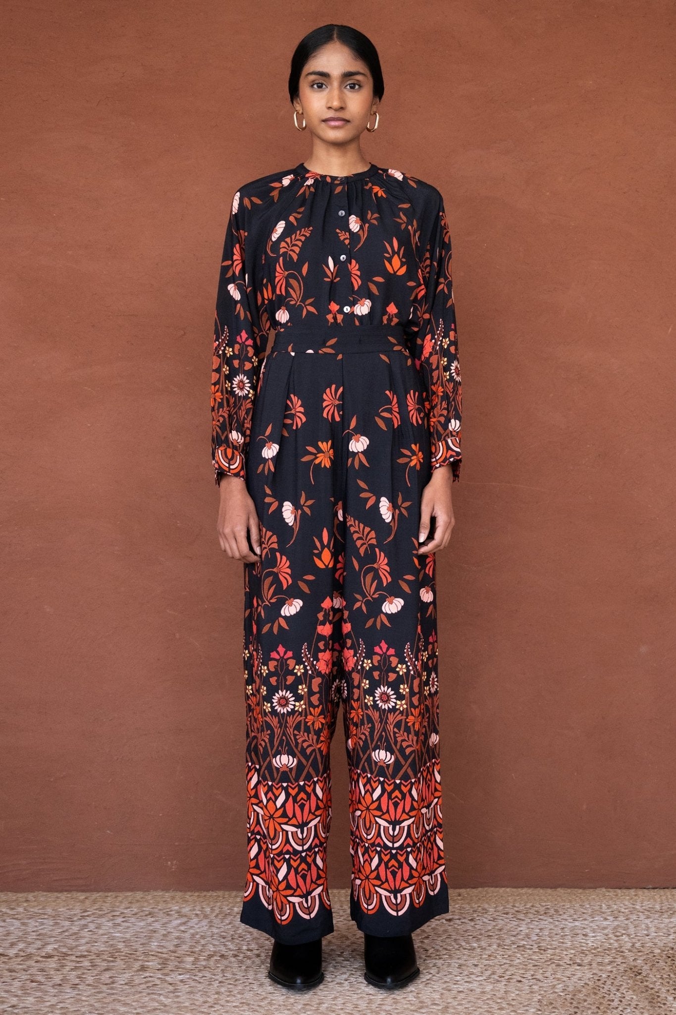 Front view of a woman wearing Killian Pant, a drapey trousers in Blumen Cedar print, featuring a fluid leg, front darts, and a drawstring waist with elastic for comfort.