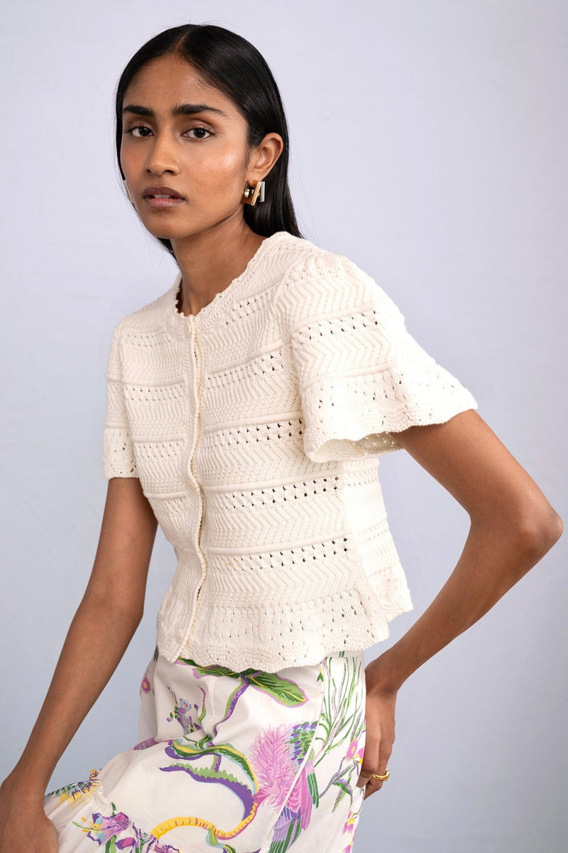 Side view of model wearing Laura Crochet Cardigan in Cream.