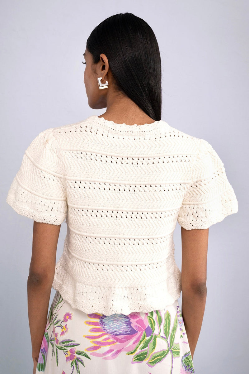 Back view of model wearing Laura Crochet Cardigan in Cream.