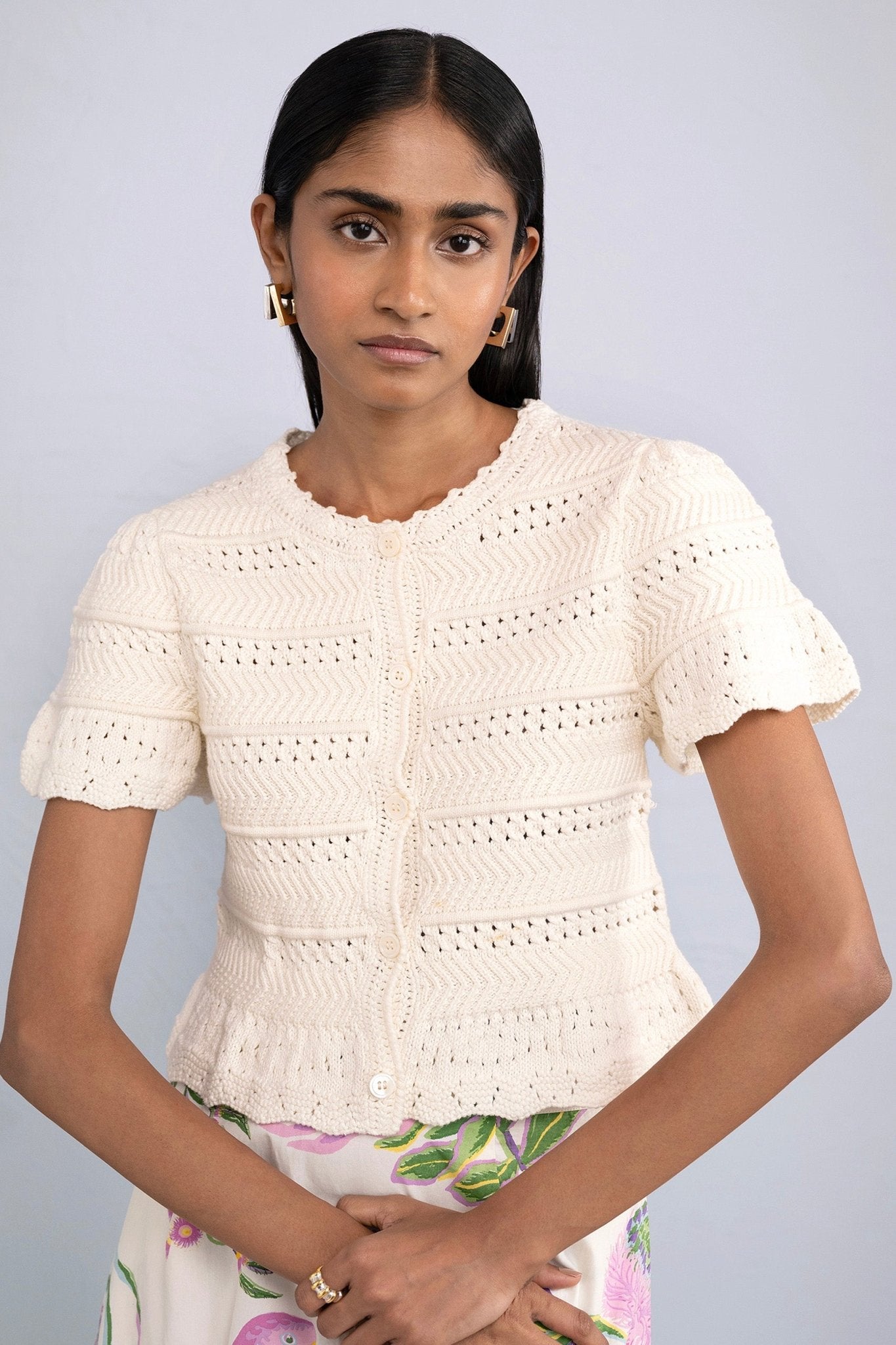 Front view of model wearing Laura Crochet Cardigan in Cream.