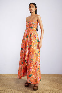 Front side view of model wearing strapless maxi Madison Dress in Bali Floral Sunset print.