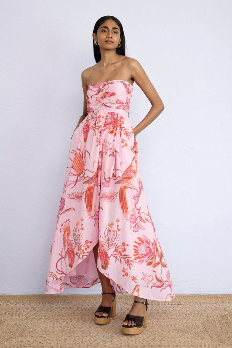 Front view of model standing wearing strapless Madison Dress in Botany Bay Pink Mist print with hands in pocket.