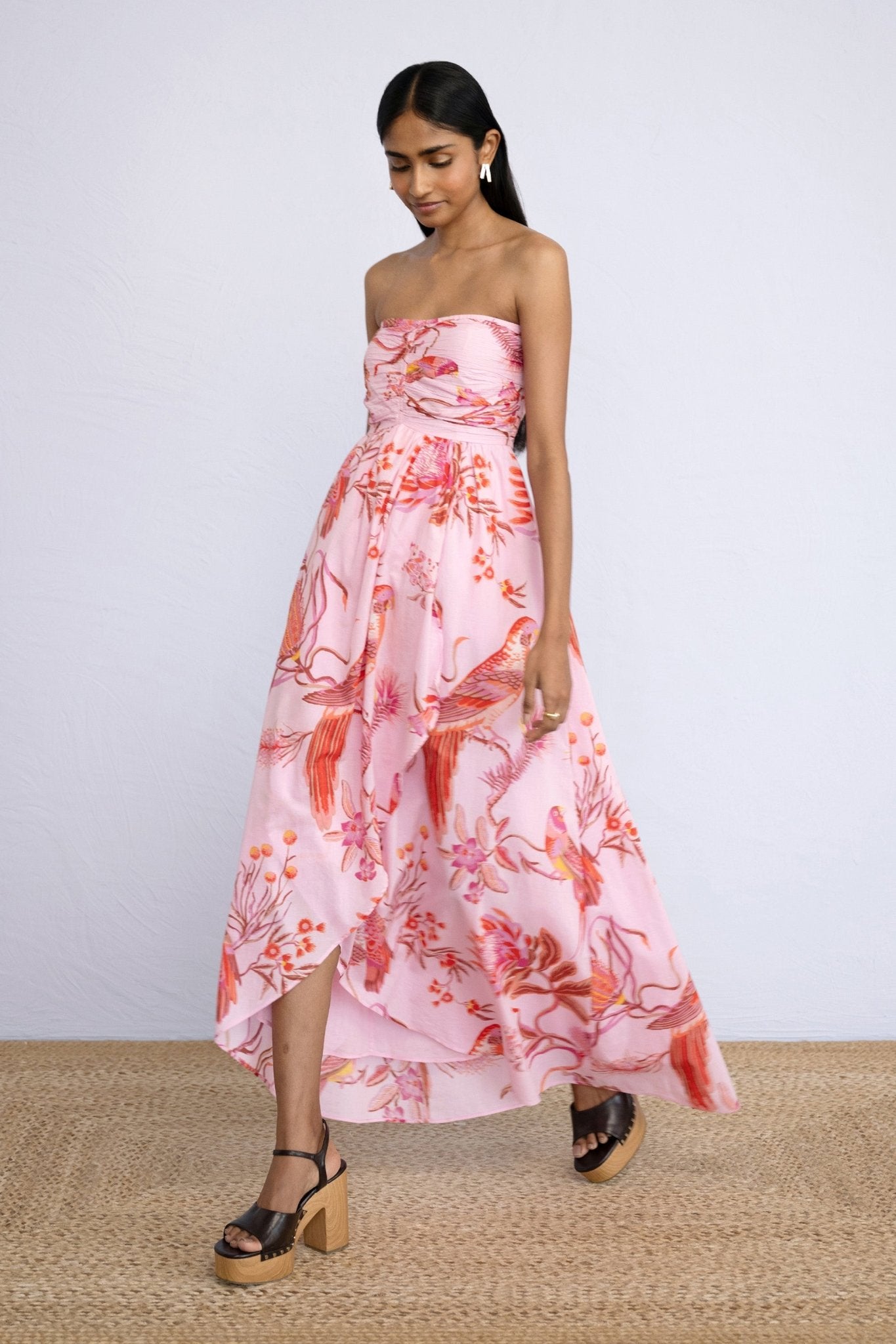 Front view of model stepping sideways wearing strapless Madison Dress in Botany Bay Pink Mist print.