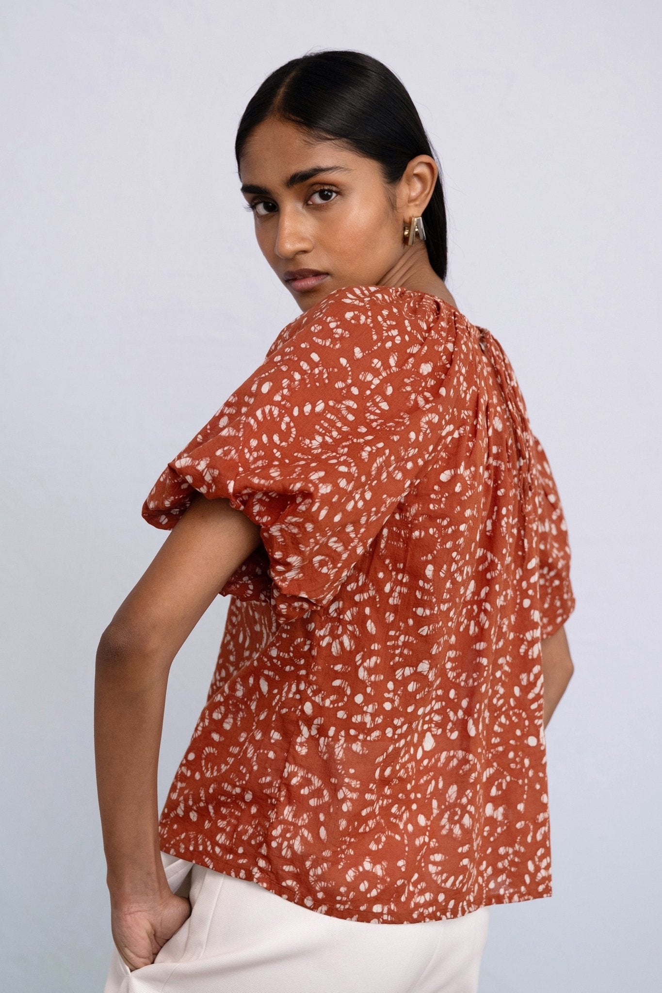 Back side view close up of model wearing Oana Top in Bondi Batik, color Tobacco.