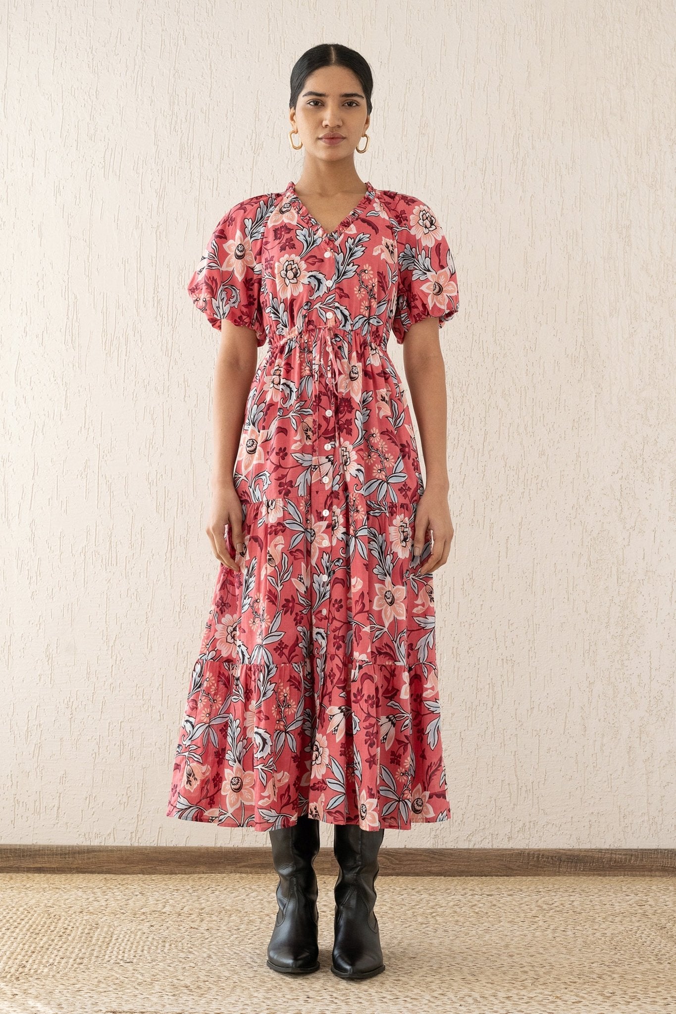 Woman standing straight wearing the Poppy dress, featuring raglan blouson sleeves, a button placket, a flowing skirt, and a drawstring waist in Elisabetta Vine Rose floral print.