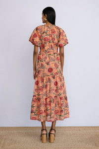 Back view of model wearing a calf length Poppy Dress in Protea Crabapple print.