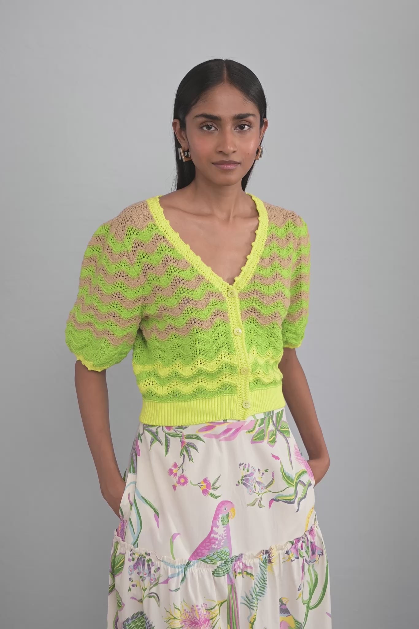 Video of model wearing Kate Chevron Cardigan Chive showing all sides of the knit.