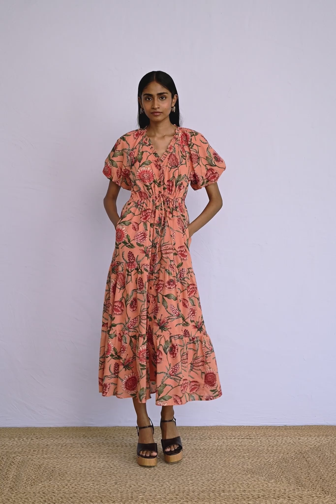 Video of model wearing a calf length Poppy Dress in Protea Crabapple print showing all sides of dress.