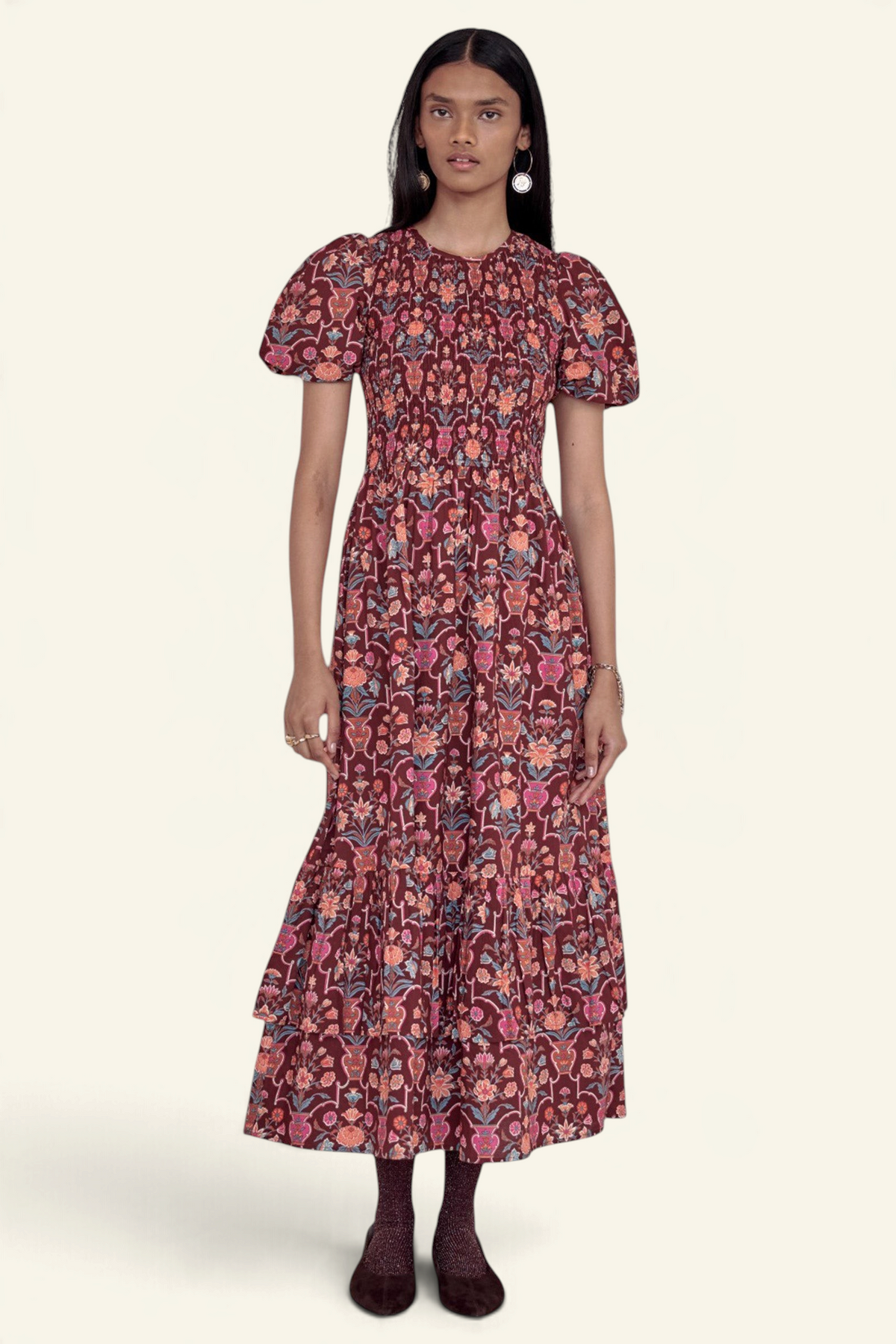 Banjanan Quant dress in chestnut floral vase print with smocked bodice, puffed sleeves, and tiered midi skirt.