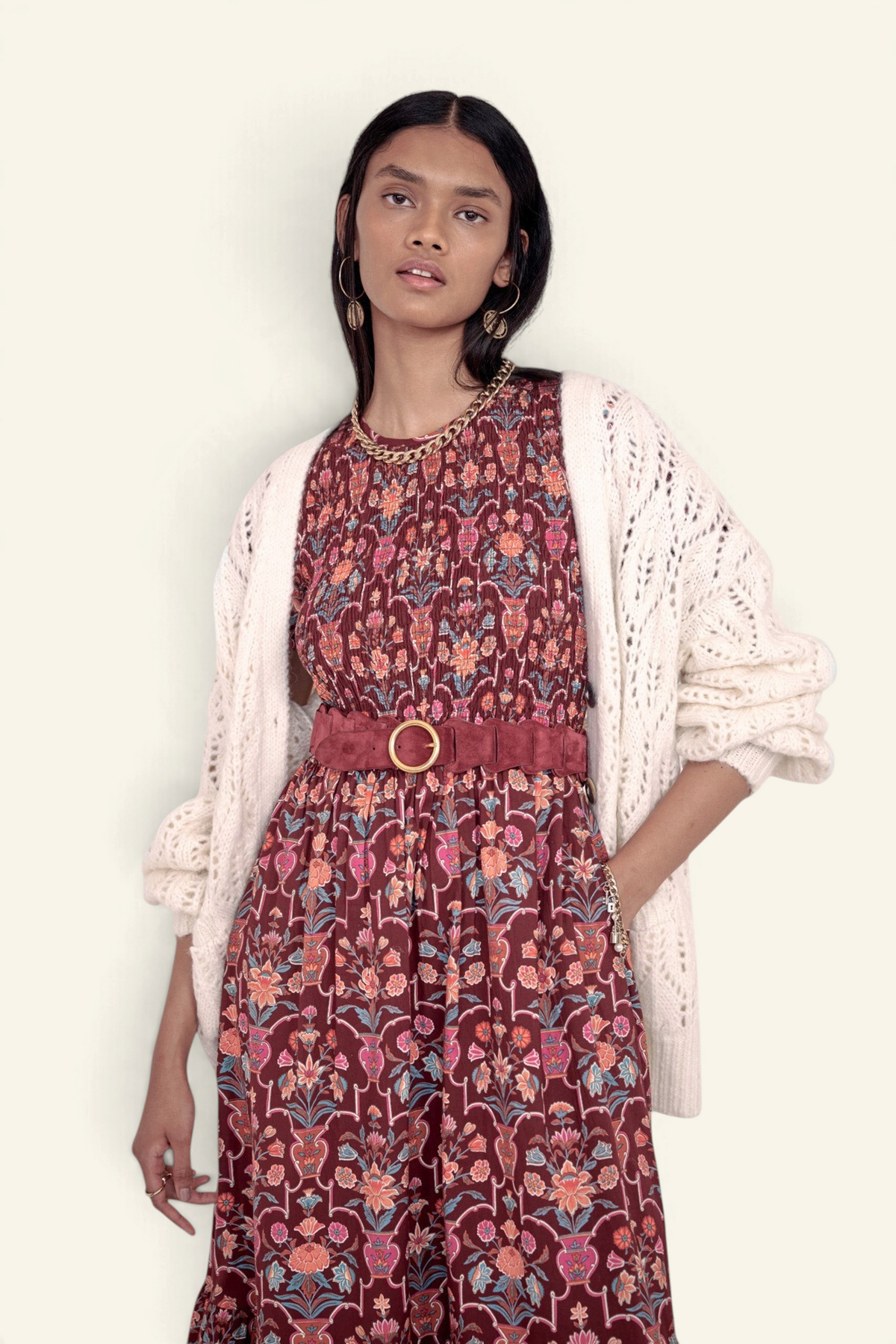 Banjanan Quant dress in chestnut floral vase print with smocked bodice, tiered skirt, and cream knit cardigan layer.