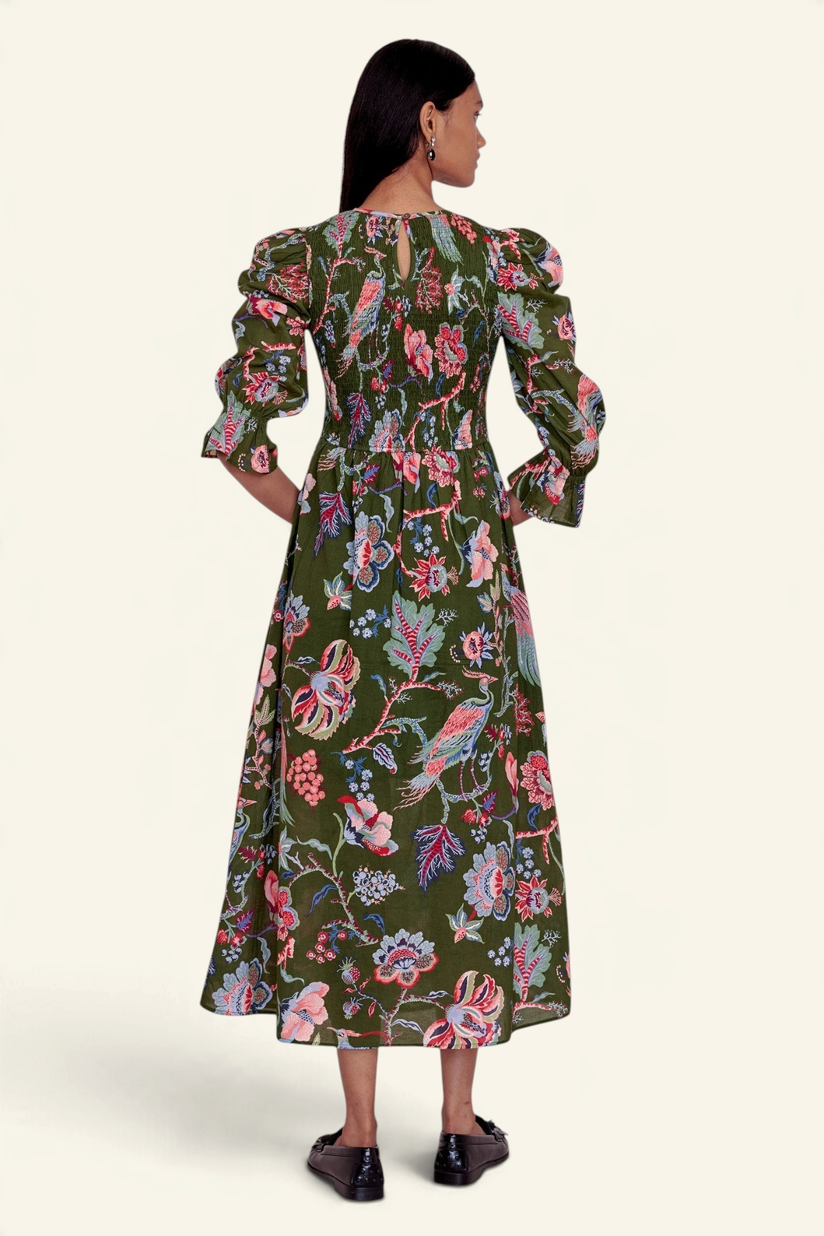 Back view of Banjanan Queenie dress in moss green chintz floral print with smocked bodice and puff sleeves.
