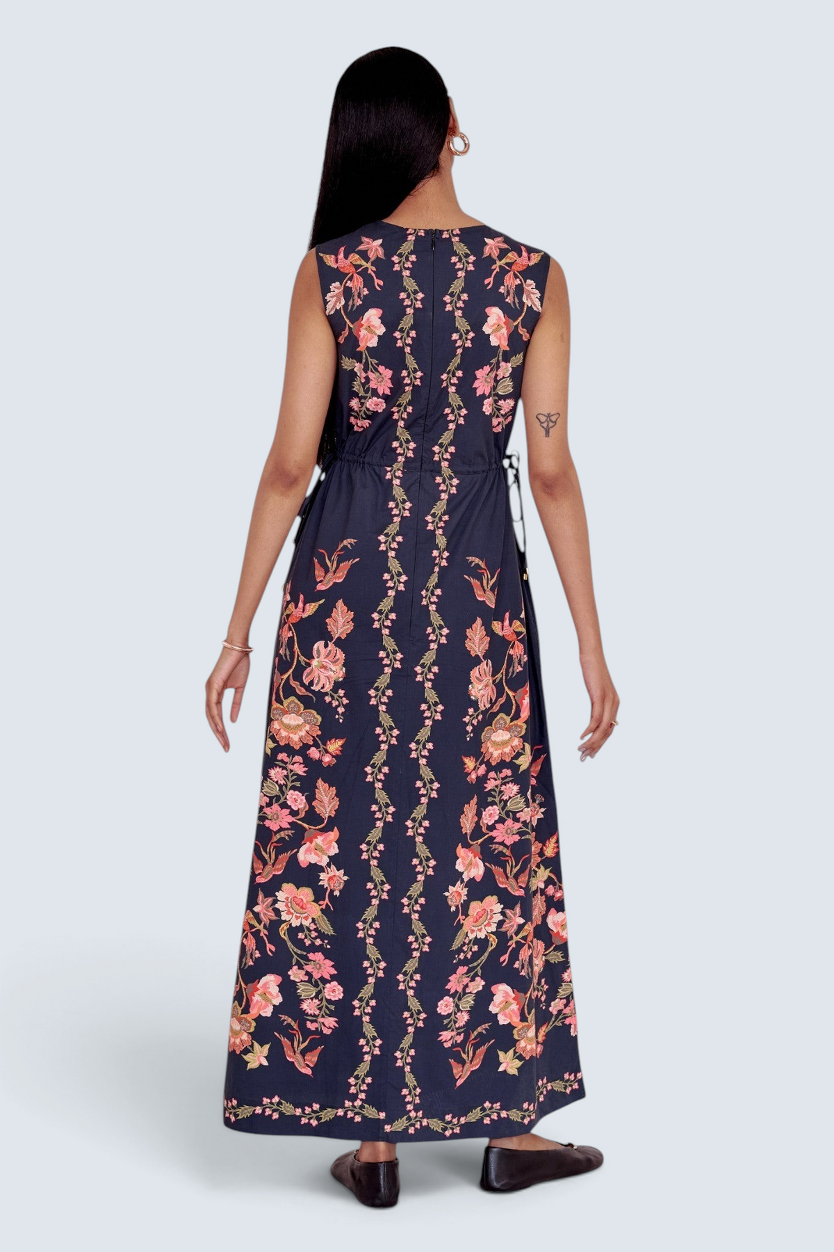 Banjanan Rhonda column dress in black with floral and bird print, featuring side drawstrings and a back view.