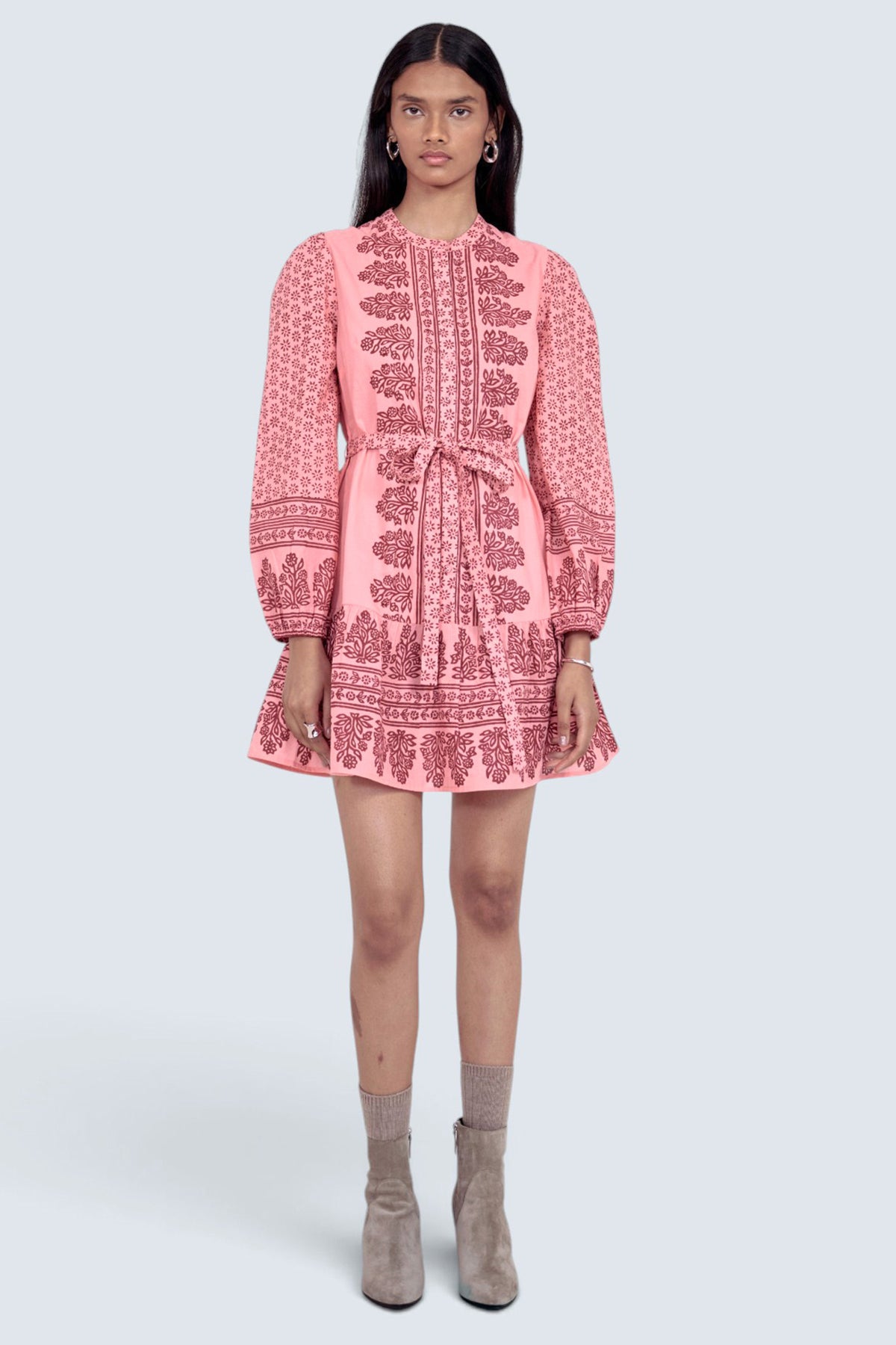 Front view of model standing wearing the Roma dress in Eugenie print, featuring a mini length, wrist-length sleeves, a detachable belt, and side-seam pockets.