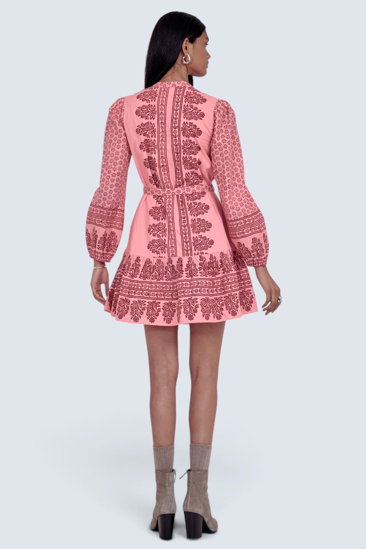 Back view of model standing wearing the Roma dress in Eugenie print, featuring a mini length, wrist-length sleeves, a detachable belt, and side-seam pockets.