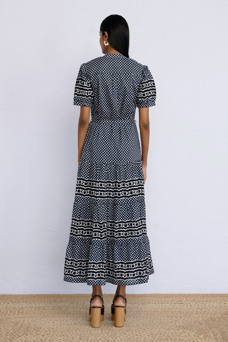 Back view of model standing wearing a full length Saylor Dress in Victorian Gingham Midnight print.