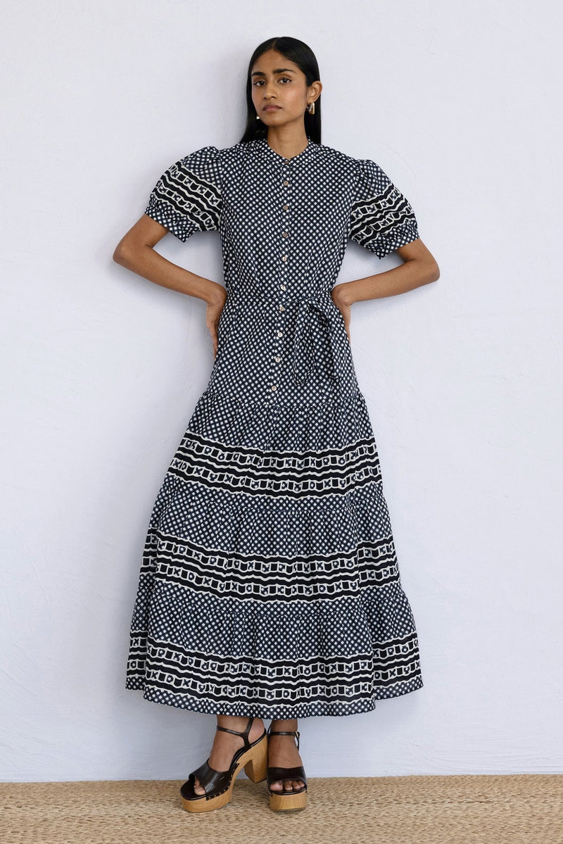 Front view of model posing wearing a full length Saylor Dress in Victorian Gingham Midnight print.