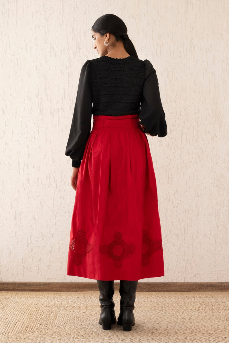 Back view of a woman wearing the Tobias skirt in Tango with a paper bag waist, self-tie belt, and pockets, featuring Art Nouveau-inspired roses in the Lace embroidery.