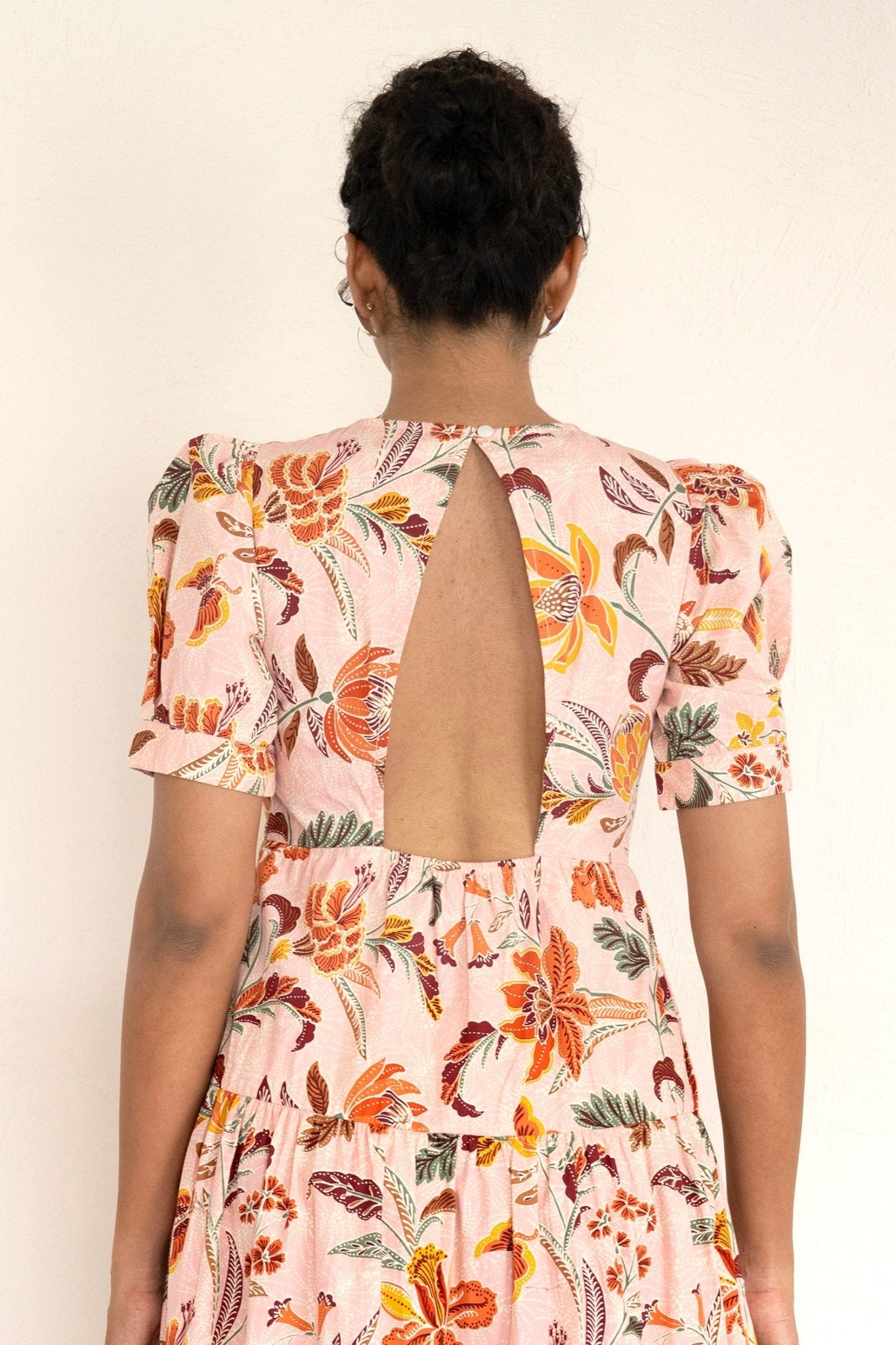 Back view of  close up woman wearing Valeria Dress Bali Floral Lotus showing details of back.