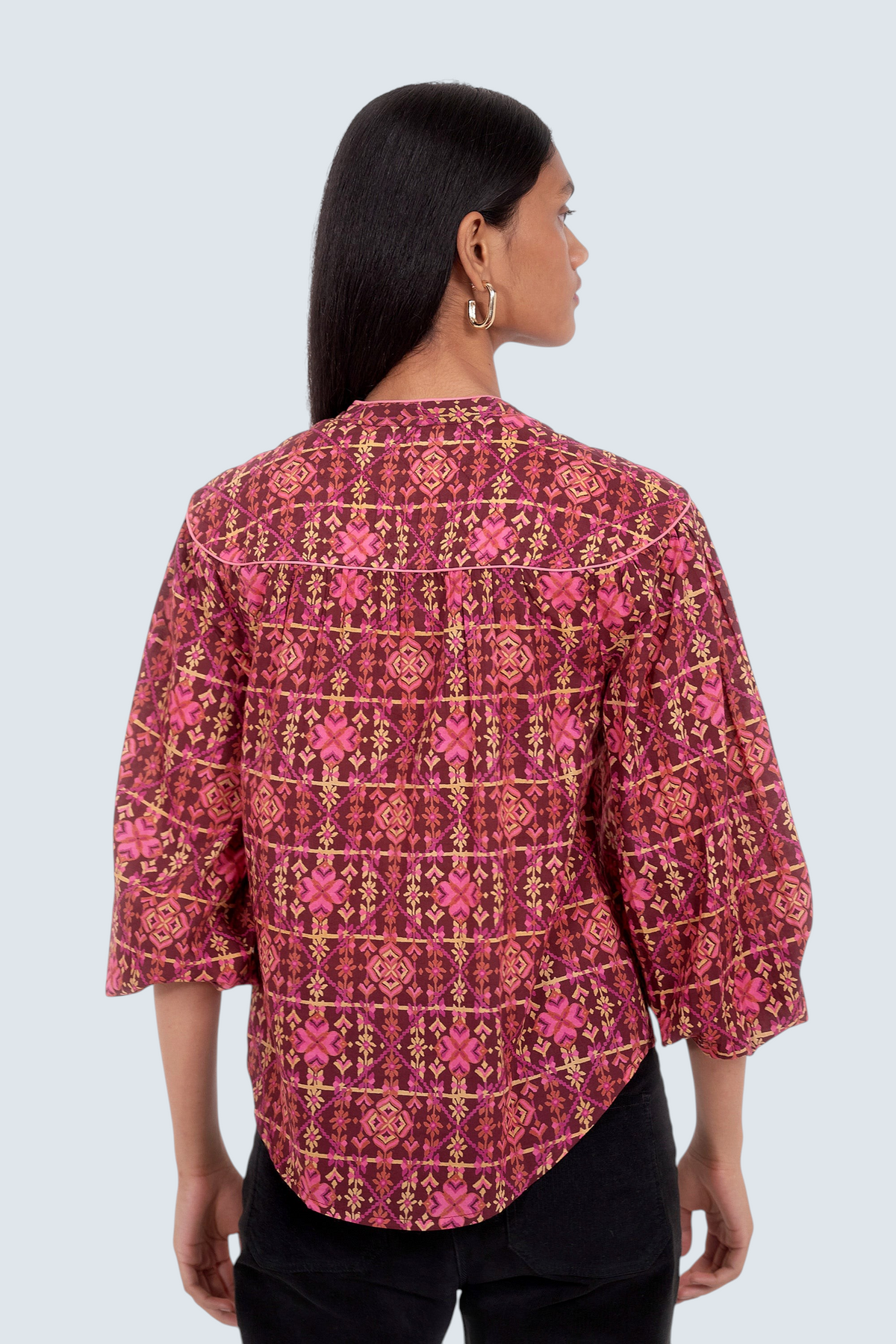 Banjanan Vanessa top in mahogany cotton voile with a geometric needlepoint floral print, v-neck, and quilted details.