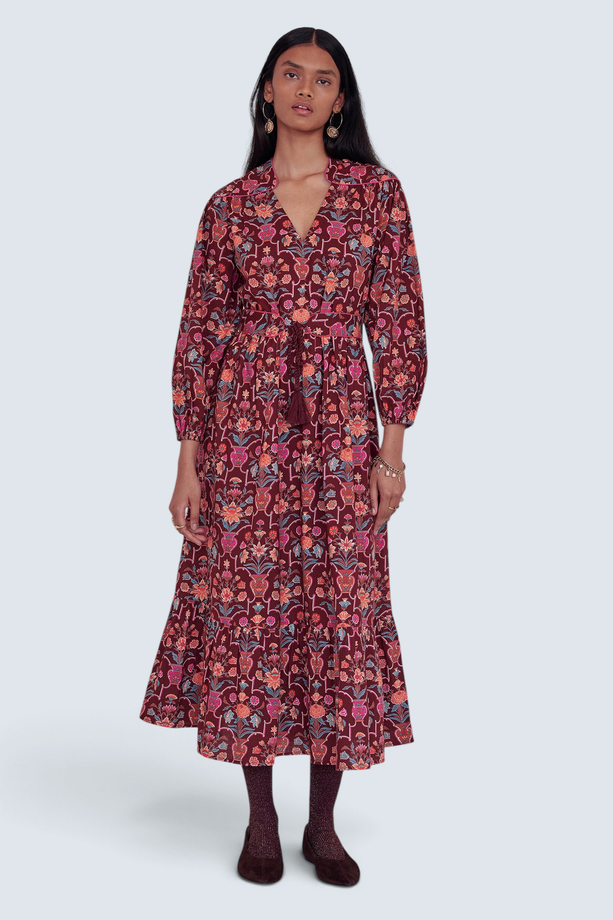 Banjanan Victoria dress in chestnut floral vase print with quilted shoulders, tassel belt, and cotton cambric fabric.